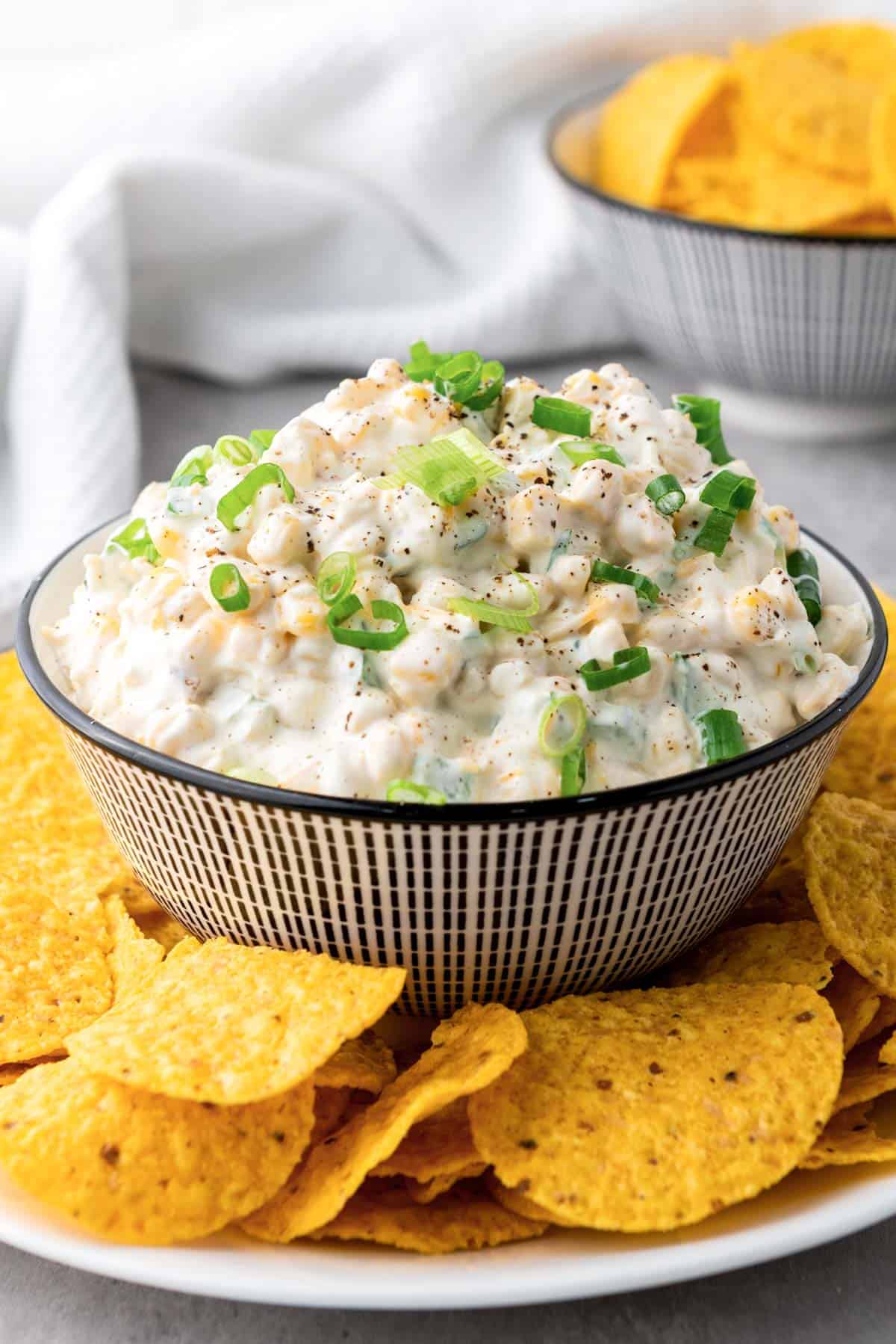 a bowl of mexican corn dip with corn chips