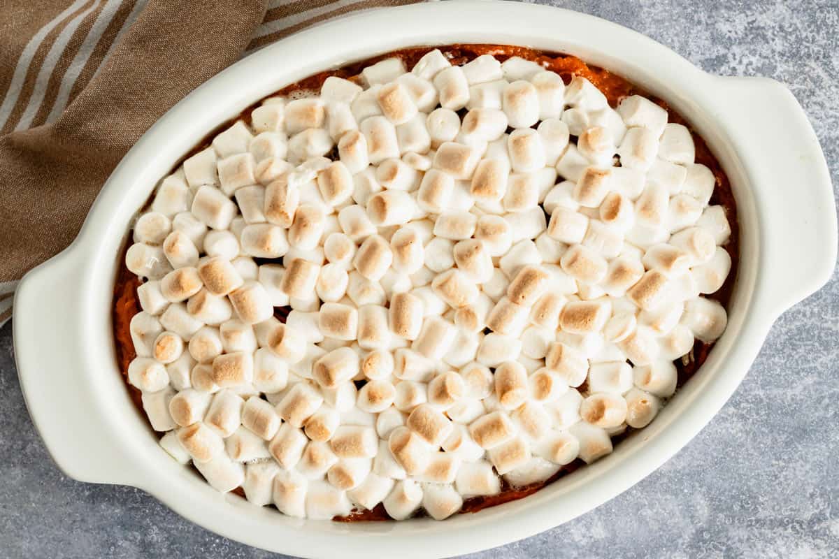 baked marshmallow topping on top of sweet potatoes.