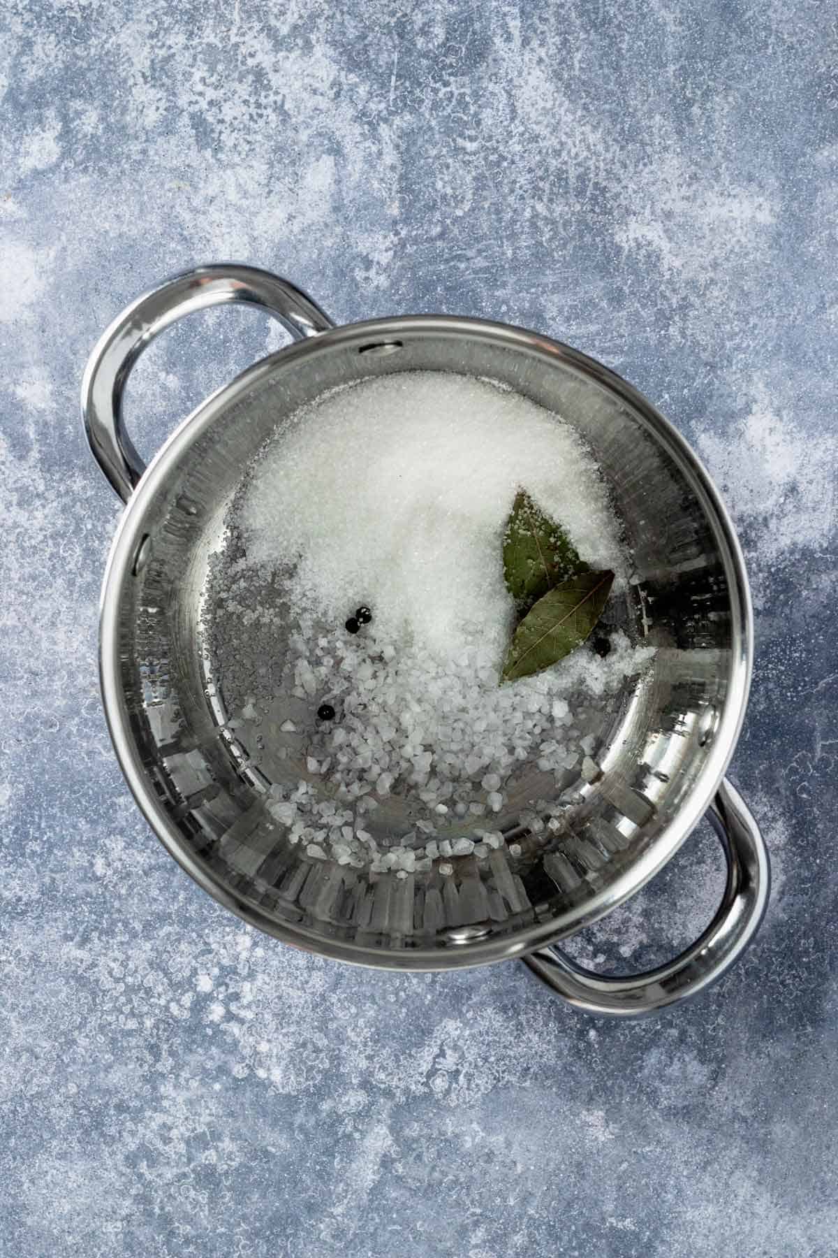 cooking the pickling liquid in a saucepot.