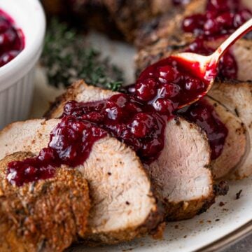 pork tenderloin slices served with berry sauce.