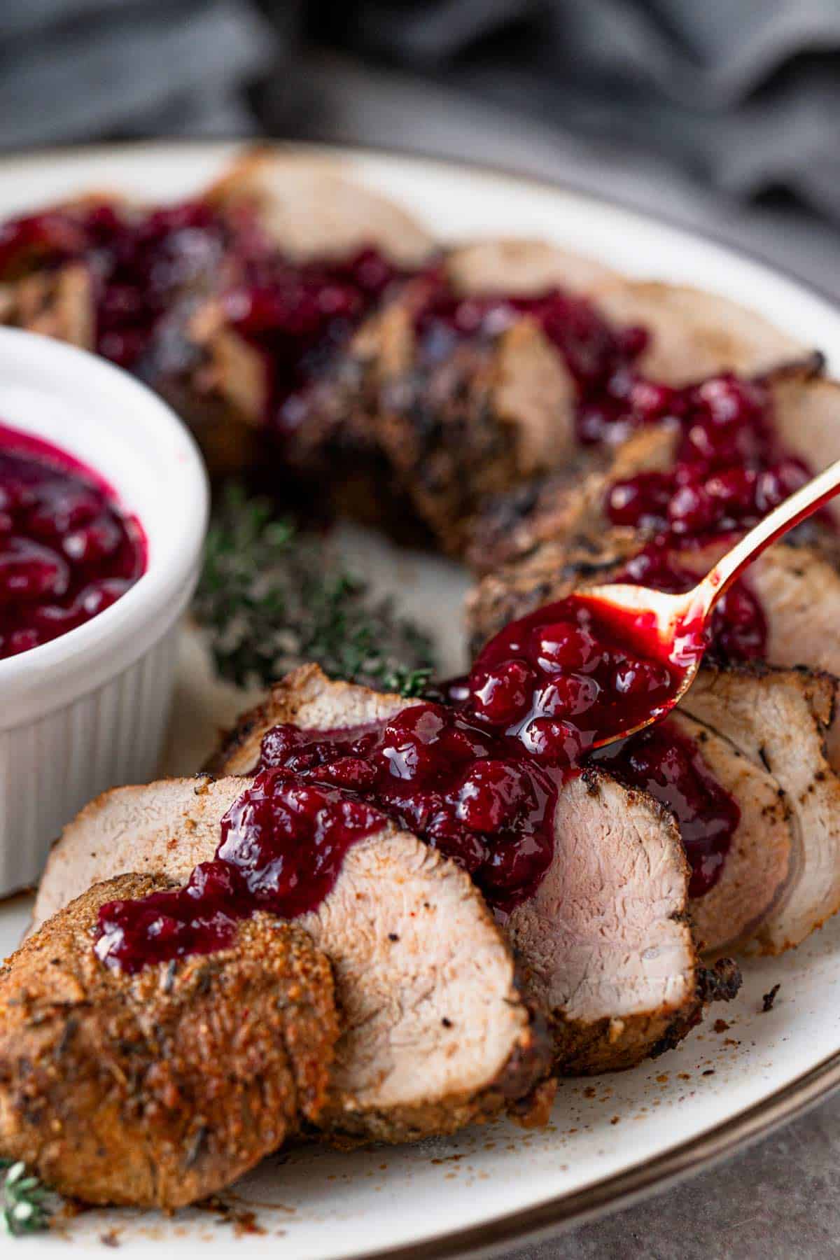 pork tenderloin slices served with berry sauce.