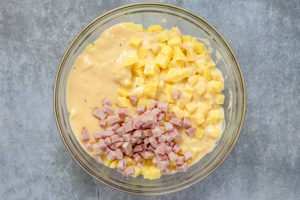 ham and potatoes with creamy sauce in a bowl