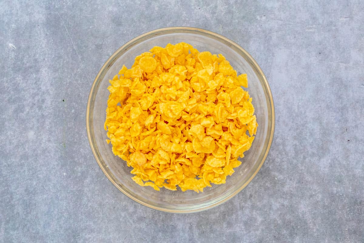 cornflakes mixed with butter in a bowl
