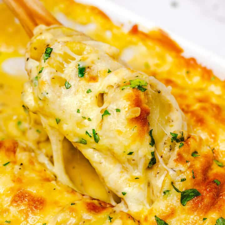 cheesy and creamy potato au gratin in a white rectangular baking dish