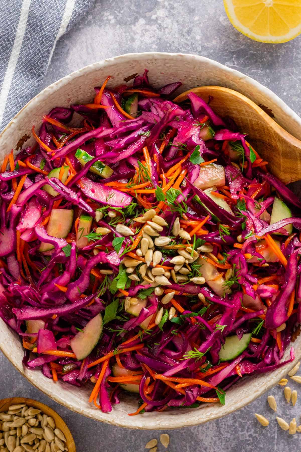 a bowl of red cabbage salad with dressing.