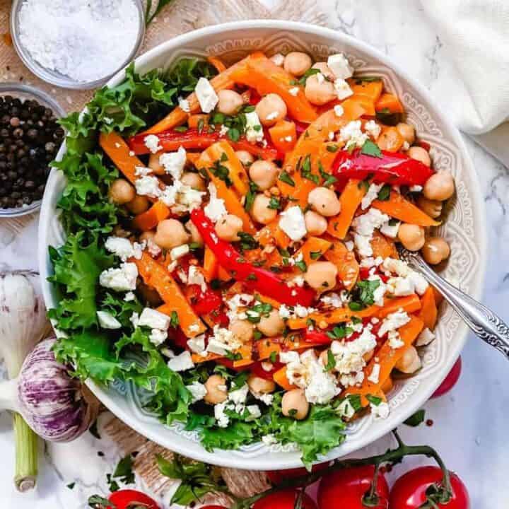 Roasted Pumpkin Chickpea and feta salad - A Delicious bowl of salad loaded with Pumpkins, bell peppers, carrots, Chickpeas and salty Feta. All this goodness is dressed in Maple Chili Dressing to add that little extra touch. -The Yummy Bowl