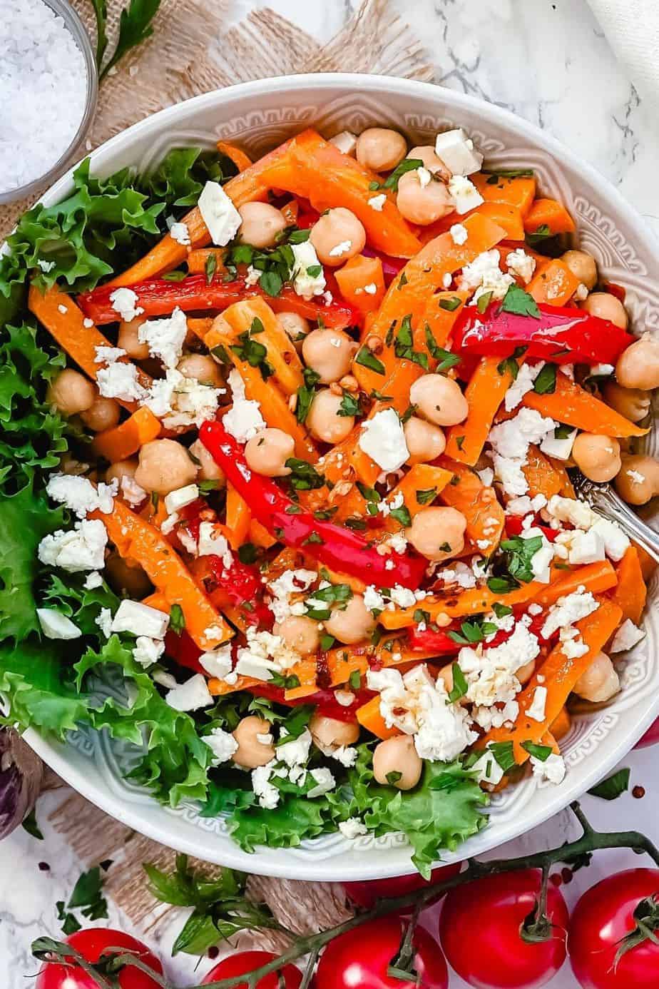 Roasted Pumpkin Chickpea and feta salad - A Delicious bowl of salad loaded with Pumpkins, bell peppers, carrots, Chickpeas and salty Feta. All this goodness is dressed in Maple Chili Dressing to add that little extra touch. -The Yummy Bowl