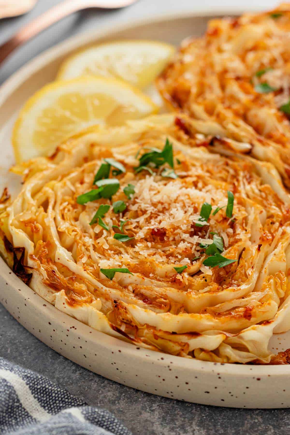 cabbage steaks with freshly grated parmesan and lime slices