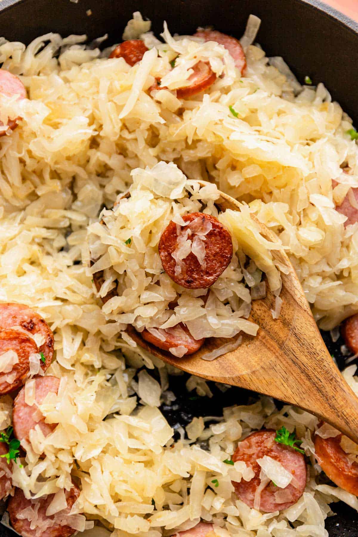 a spoonful of cooked sauerkraut and kielbasa skillet.