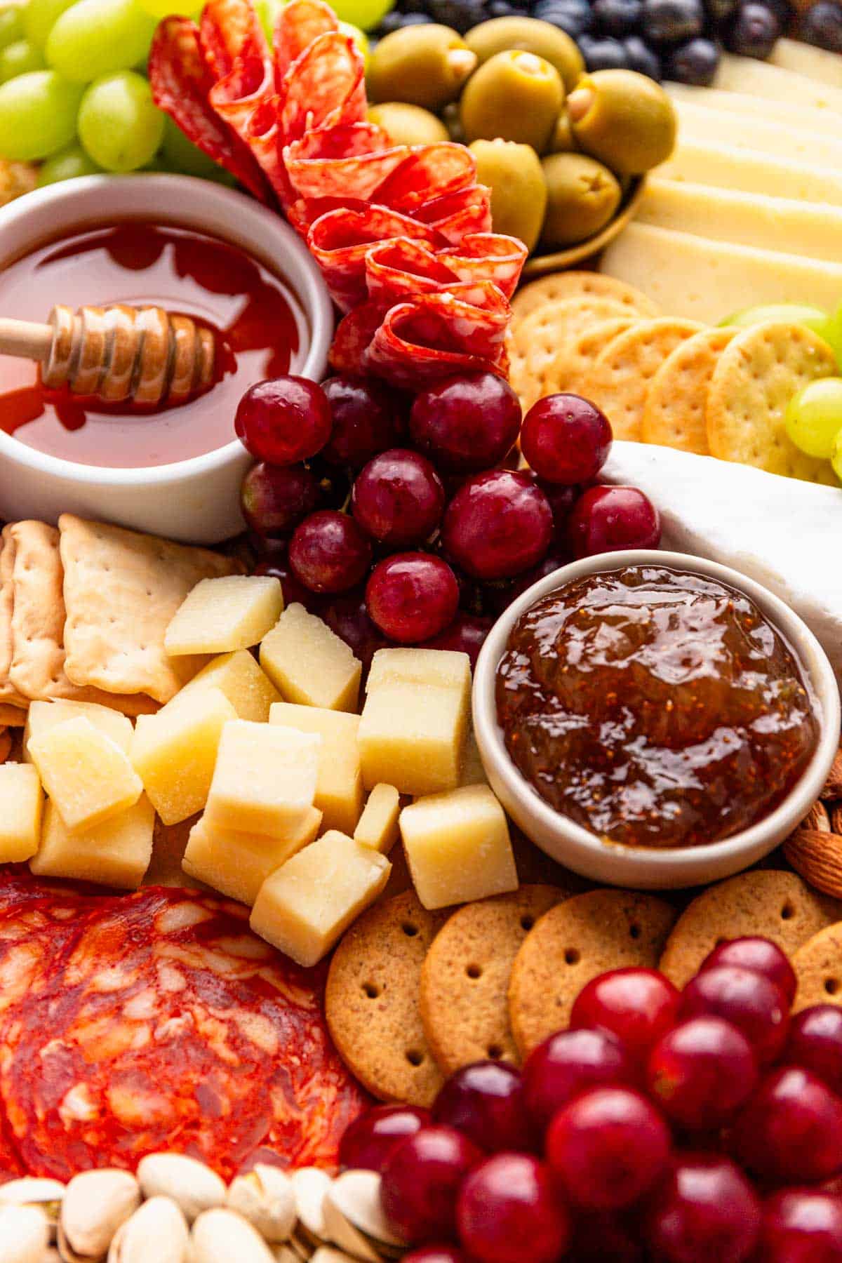 simple charcuterie board with meat cuts, cheese and fruit.