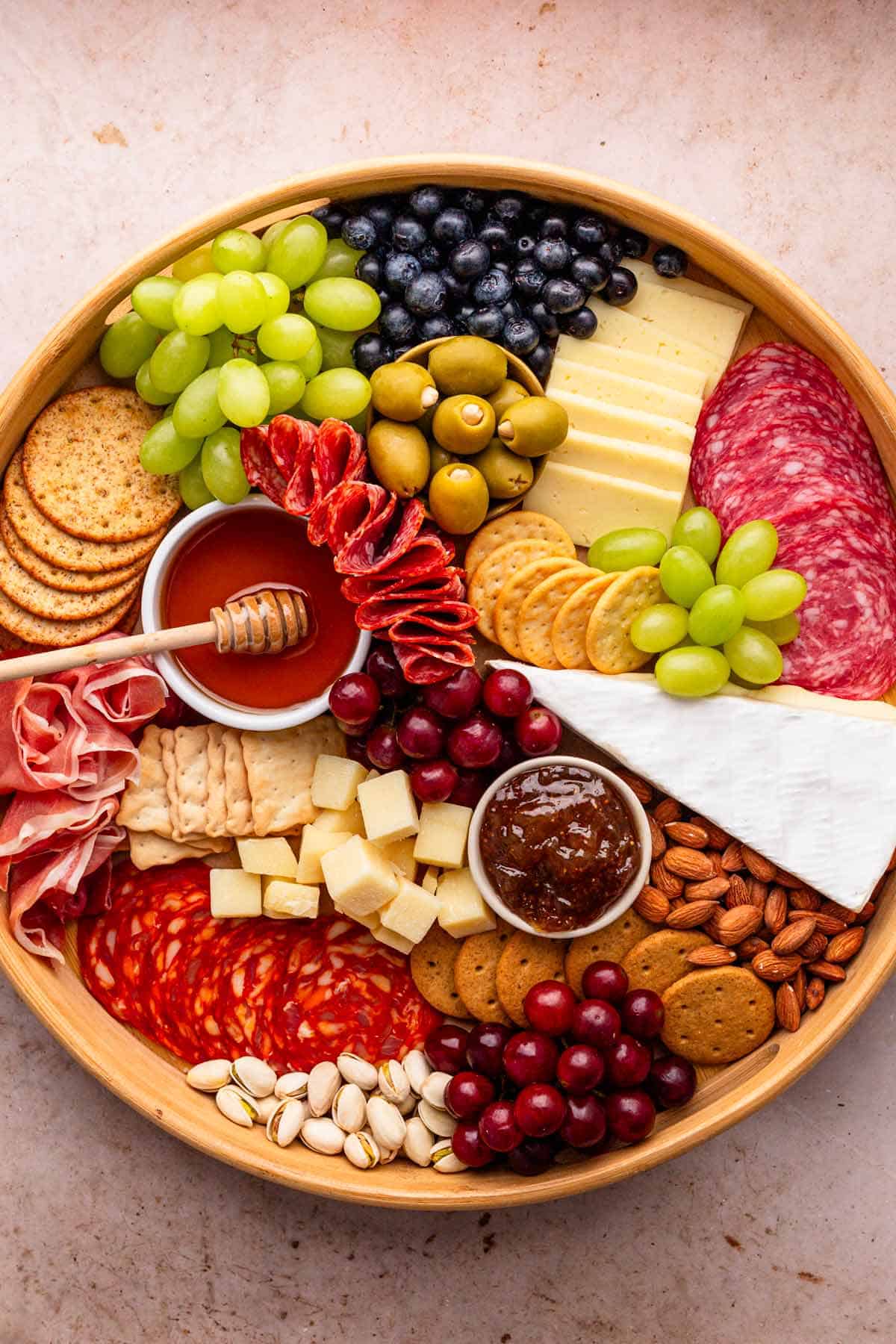 charcuterie board with meat cuts, cheese and fruit.