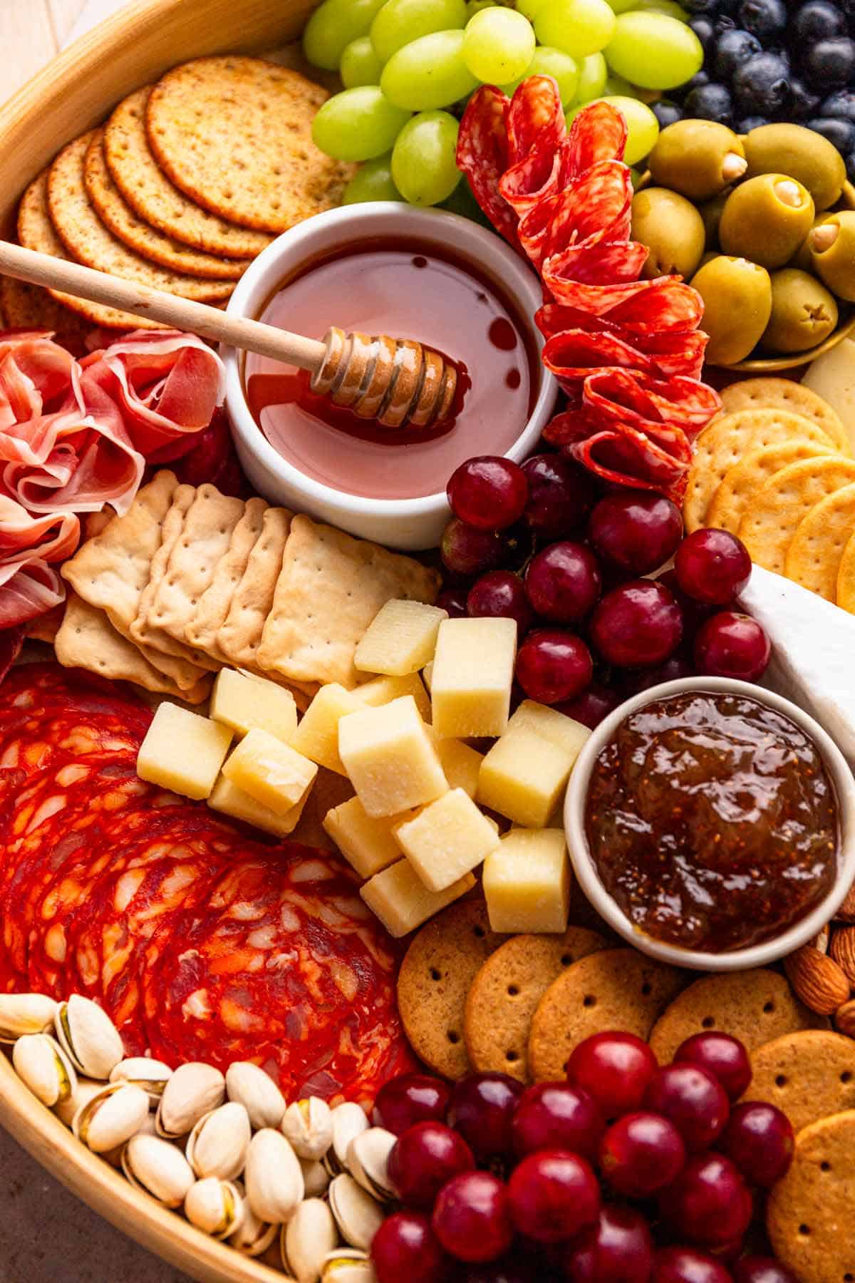 charcuterie board with meat cuts, cheese and fruit.