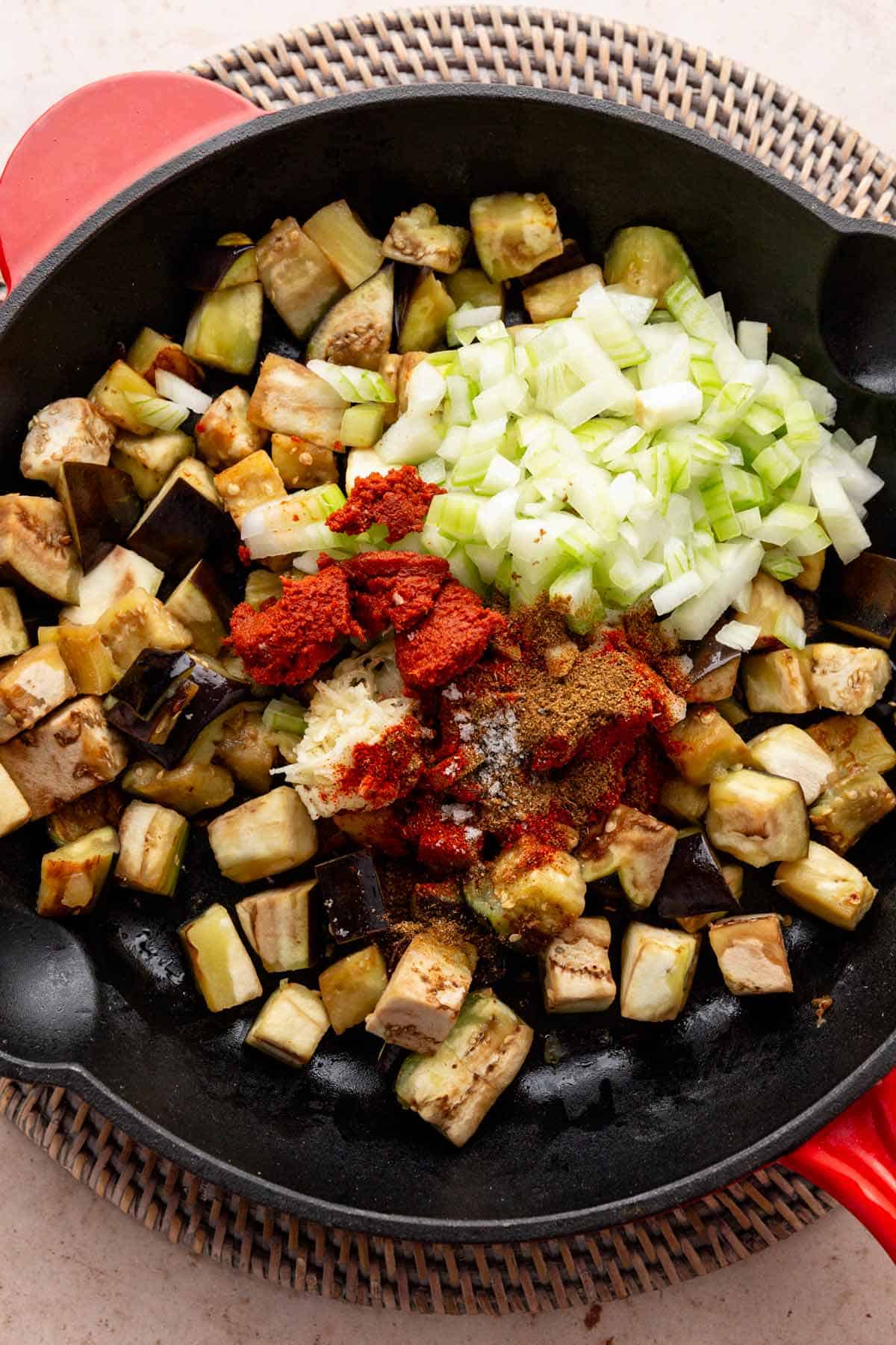 adding spices and curry paste to eggplant skillet.