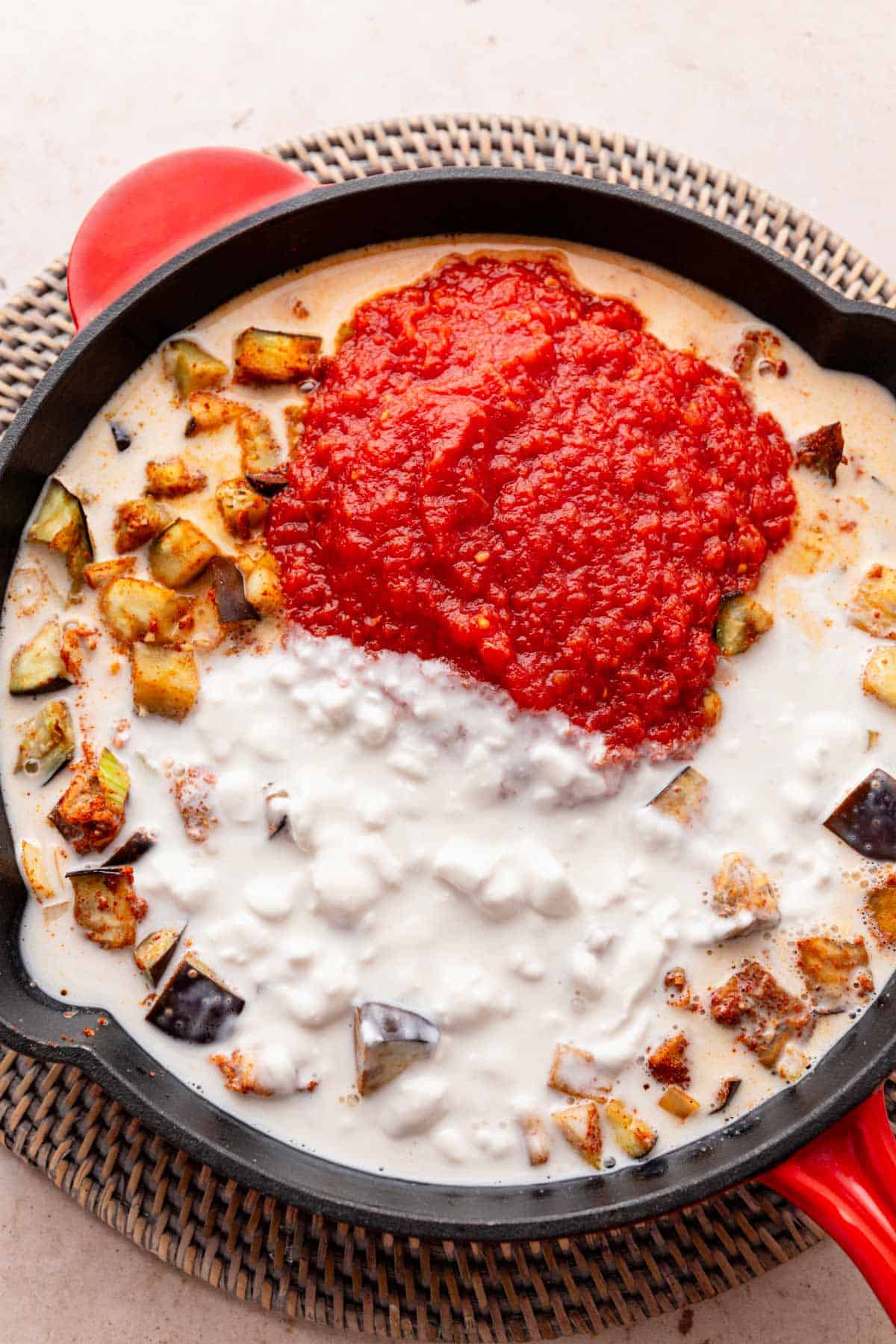 coconut milk and crushed tomatoes added to skillet.