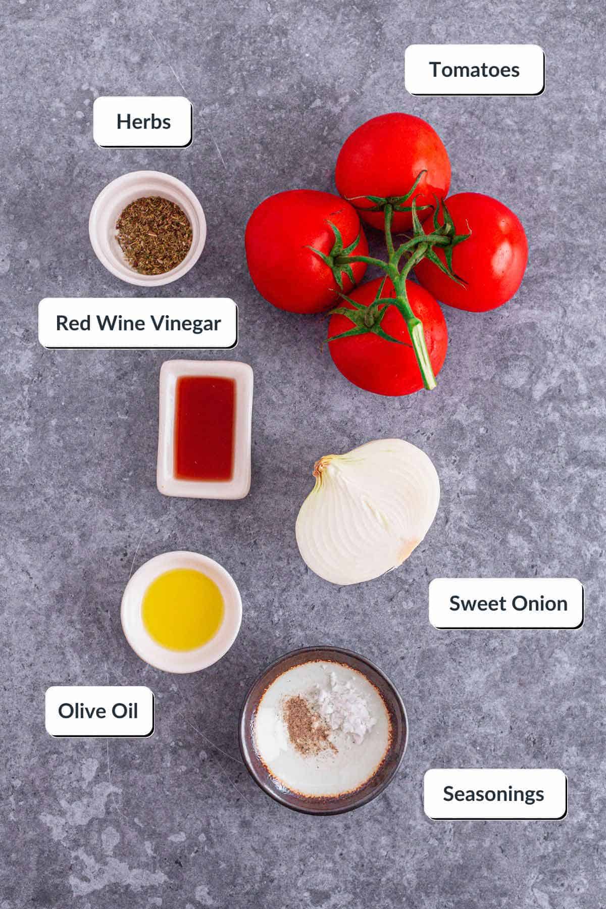 Tomato and Onion Salad with herbs in a black bowl