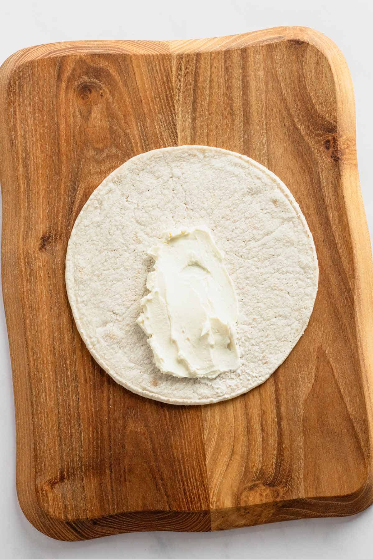 cream cheese on tortilla wrap.