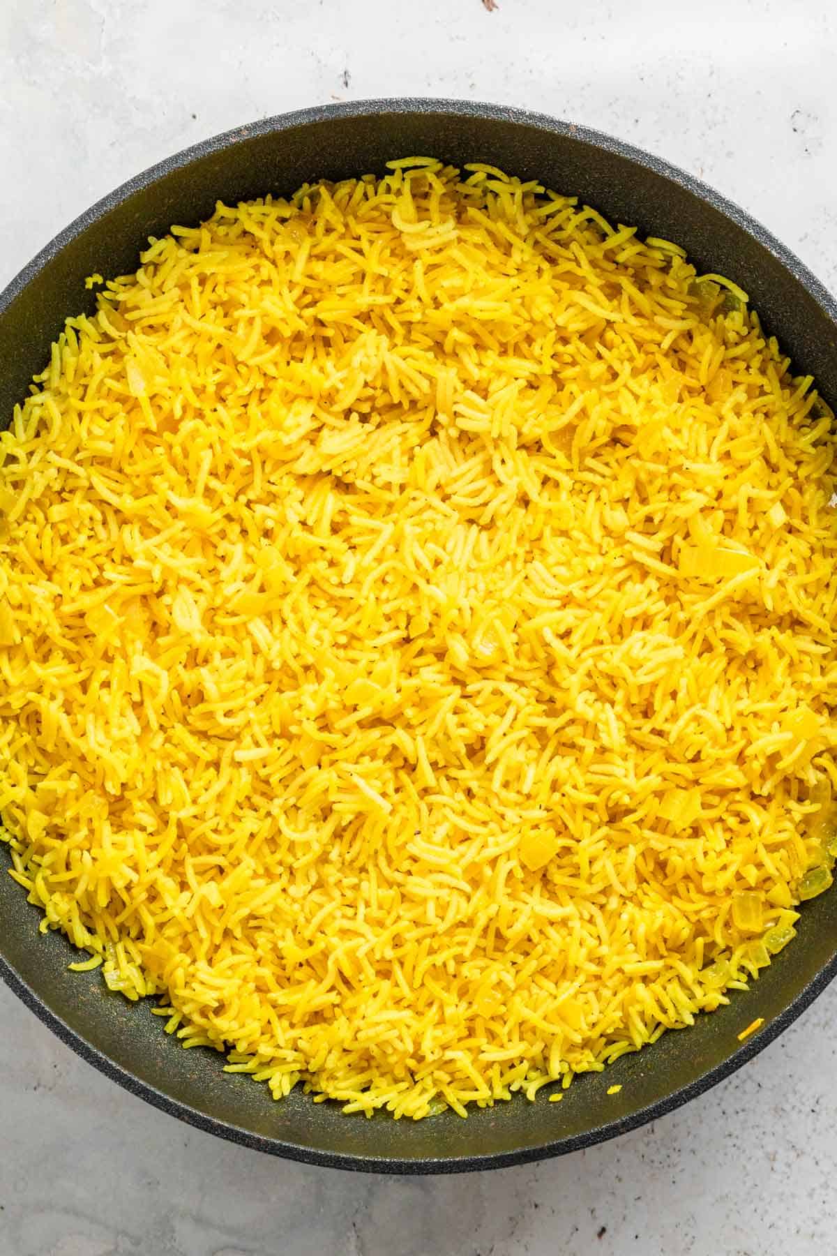 steamed yellow rice in skillet.