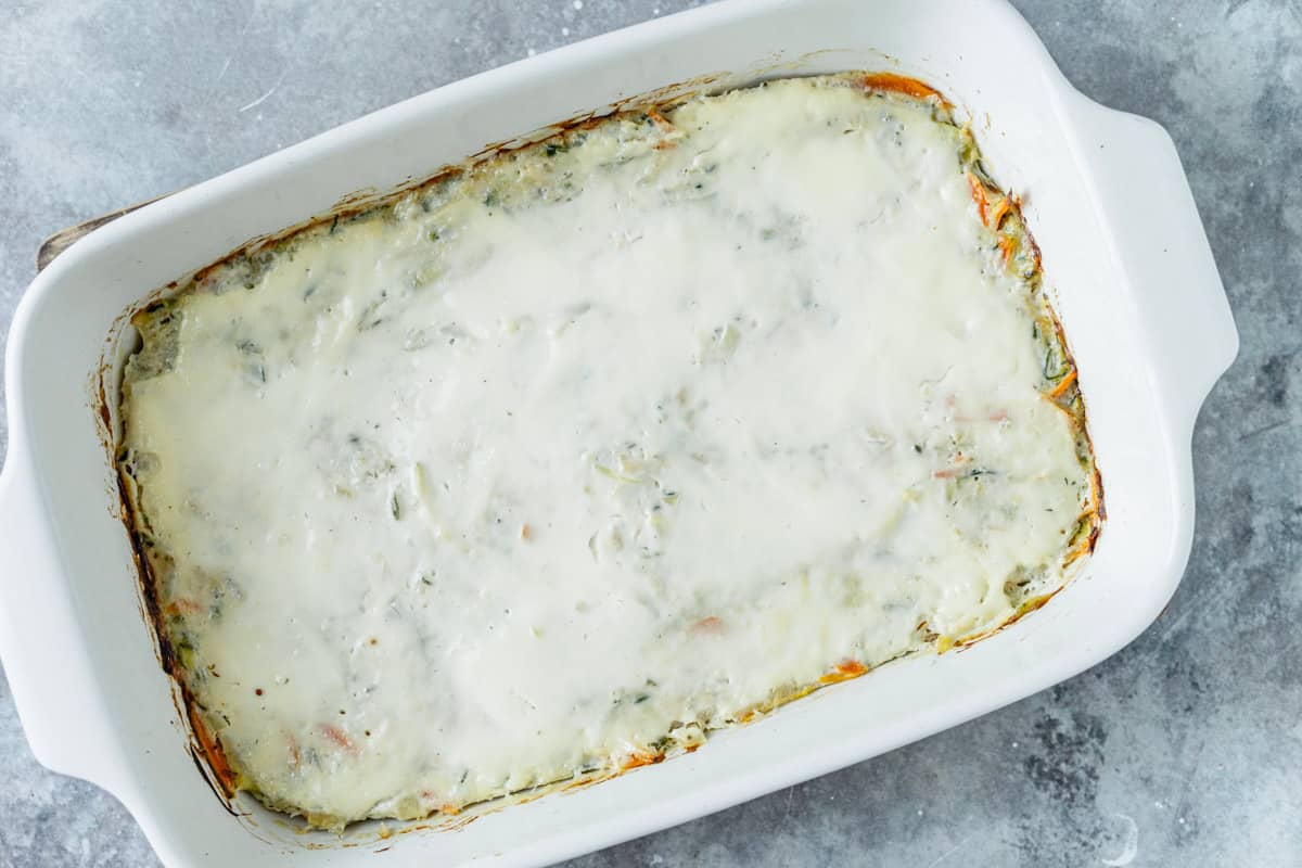 Chicken Zucchini Casserole in a white oval baking dish before baking