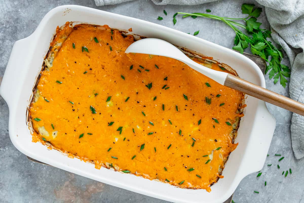 Chicken Zucchini Casserole in a white oval baking dish against grey background