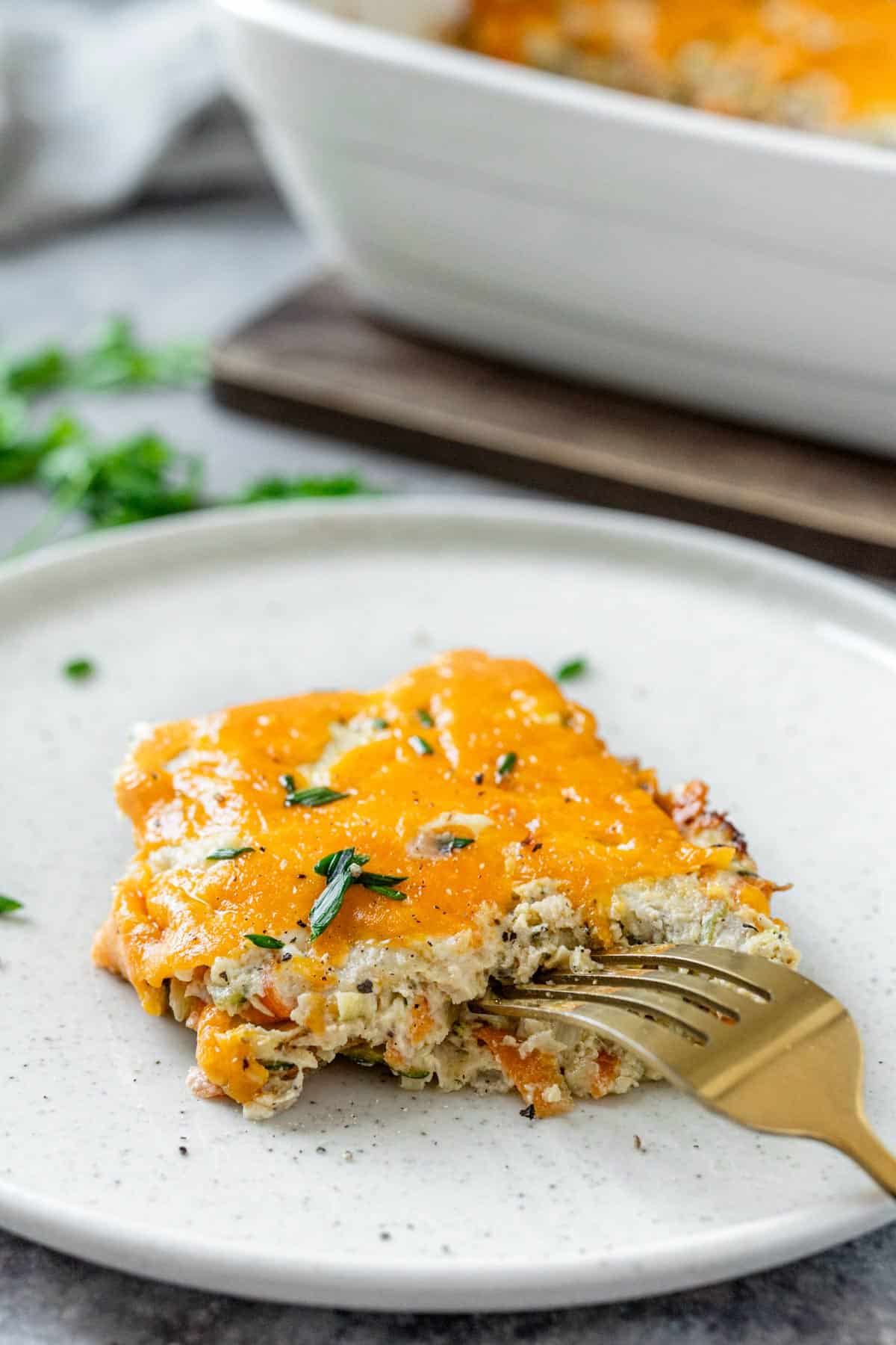 zucchini chicken casserole on a white plate close up bite shot