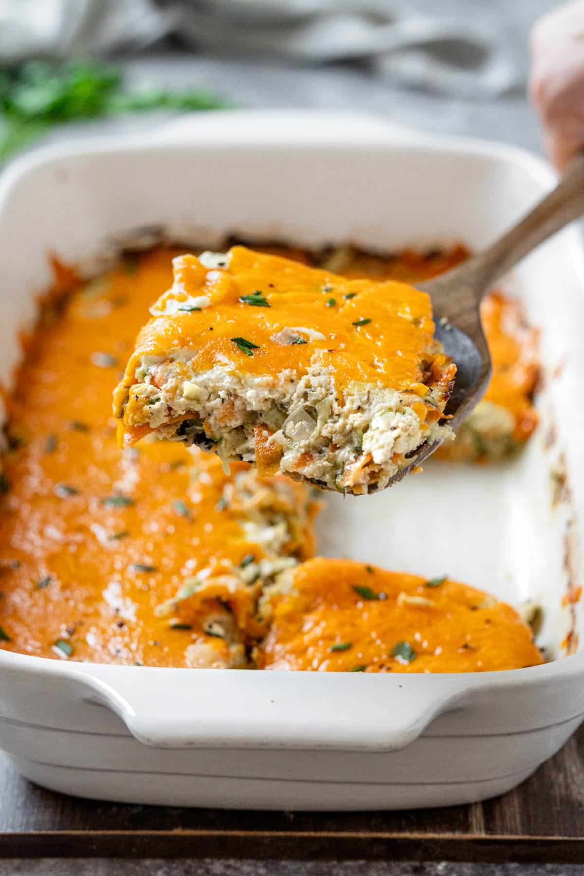 zucchini chicken casserole closeup on a wooden spoon